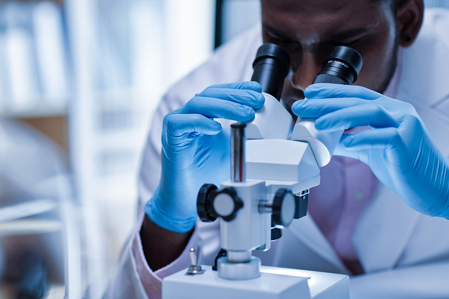 Life sciences researcher at microscope